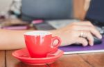 Red Coffee Cup On Work Station Stock Photo