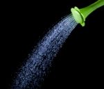 Pouring Water From Green Watering Can Stock Photo