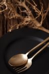 Black Empty Plate Fork Spoon On Wooden Table Background Stock Photo