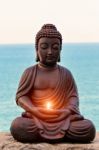 Buddha With A Candle In Hands Stock Photo