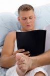 Resting Male Reading Report Stock Photo