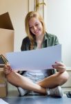 Young Beautiful Woman Moving In New Home Stock Photo