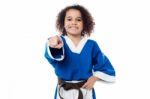 Smiling Karate Girl Pointing Towards You Stock Photo