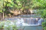 The Water Flowing Over Rocks And Trees Down A Waterfall At Huay Mae Khamin Waterfall National Park ,kanchana Buri In Thailand Stock Photo