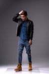 Casual Young Man In Black Leather Jacket And Denim Jeans Stock Photo