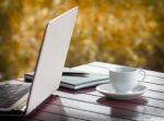 Laptop And Cup Of Coffee On Desk Stock Photo