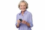 Aged Woman Texting On Her Mobile Phone Stock Photo