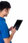 Young Guy Browsing On Tablet Device Stock Photo