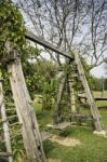 Outdoor Wooden Swing In Field Stock Photo