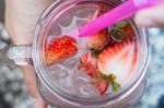 Hand Hold Glass Of Iced Strawberry Soda Drink Stock Photo