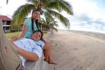 Couple Relaxing At Beach Stock Photo