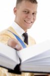 Smiling Student Showing His Book Stock Photo