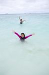 Girl Playing On Sea Beach With Happy Face Stock Photo