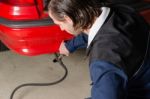 Mechanic Measuring Exhausts Of A Car In Garage Stock Photo