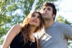 Outdoor Portrait Of Young Caucasian Couple At The Park Stock Photo