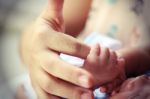 Hand Of A Baby Holding Mother's Finger Stock Photo