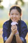 Thai 12s Years Girl Sitting On Garden Field With Pink Flowers In Hand Toothy Smiling Face Happiness Emotion Stock Photo