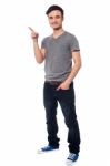 Young Man Pointing At Something Interesting Stock Photo