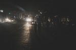 Father Walking With His Two Kids At Night In The City Stock Photo