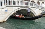 Gondolier Ferrying People In Venice Stock Photo