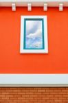 Sky Reflection In Window Glass On Orange Wall Stock Photo