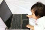 Baby Is Playing A Computer Stock Photo