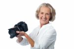 Experienced Female Photographer With Camera Stock Photo