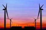 Silhouette Wind Turbine Generator With Factory Emissions Of Carb Stock Photo