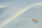 Wedding Rings In The Snow Stock Photo