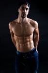 Beautiful And Muscular Man In Dark Background Stock Photo