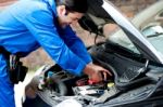 Smiling Mechanic Repairing  Car Engine Stock Photo