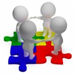 Puzzle Solved And 3d Characters Showing Unity And Teamwork Stock Photo