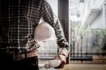 Smart Businessman Holding Construction Helmet And Blueprints In Stock Photo