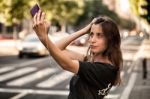 Young  Woman Taking A Photo With Her Phone Stock Photo