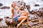 Beautiful Young Blonde Woman Posing Outdoor At The Rocky Sea Sho Stock Photo