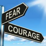 Fear Courage Signpost Shows Scared Or Courageous Stock Photo