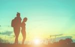 Silhouette Of Woman Praying Over Beautiful Sky Background Stock Photo