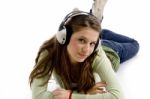 Lying Woman Enjoying Music Stock Photo