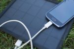 Mobile Phone Charging With Solar Energy - Charger Stock Photo