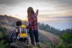 Female Tourists And Men Are Viewing The Mountain Stock Photo