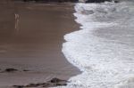 Lonely People Walk On Beach Stock Photo