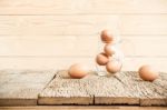 Eggs In Glass On Old Wooden Table Stock Photo