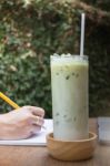 Matcha Tea With Milk On Creative Work Table Stock Photo