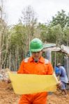 Excavator And Workers Stock Photo