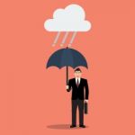 Businessman With Umbrella In Rain Stock Photo