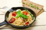 Spaghetti Pasta With Baked Cherry Tomatoes And Basil Stock Photo