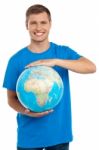 Young Male Holding Globe Stock Photo