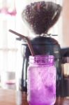 Iced Drink In Violet Glass In Coffee Shop Stock Photo