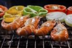 Shrimp Grilled On Barbecue Stove With Chilly And Onion Ring Stock Photo