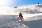 Female Skier In Fresh Powder Snow And Sunlight Stock Photo